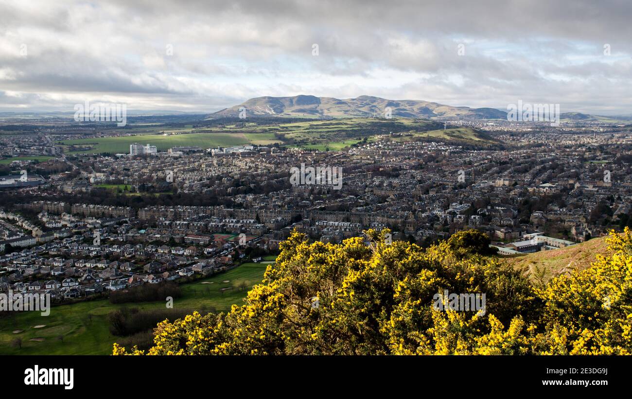 The sun shines on the Pentland Hills and South Edinburgh during a partial eclipse in March 2015. Stock Photo