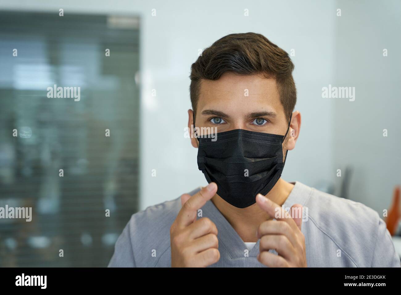 Mindful doctor showing a correct way to wear a mask Stock Photo