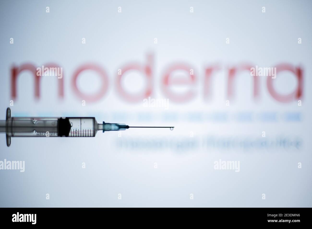 Barcelona, Catalonia, Spain. 18th Jan, 2021. In this illustration photo a syringe is seen in front of the Moderna logo.Spain begins to administer the second dose of the Pfizer and BioNTech drug vaccine and the first dose (35,700 doses) of Moderna's drug has been incorporated, which also requires two injections per person. Credit: Thiago Prudencio/DAX/ZUMA Wire/Alamy Live News Stock Photo