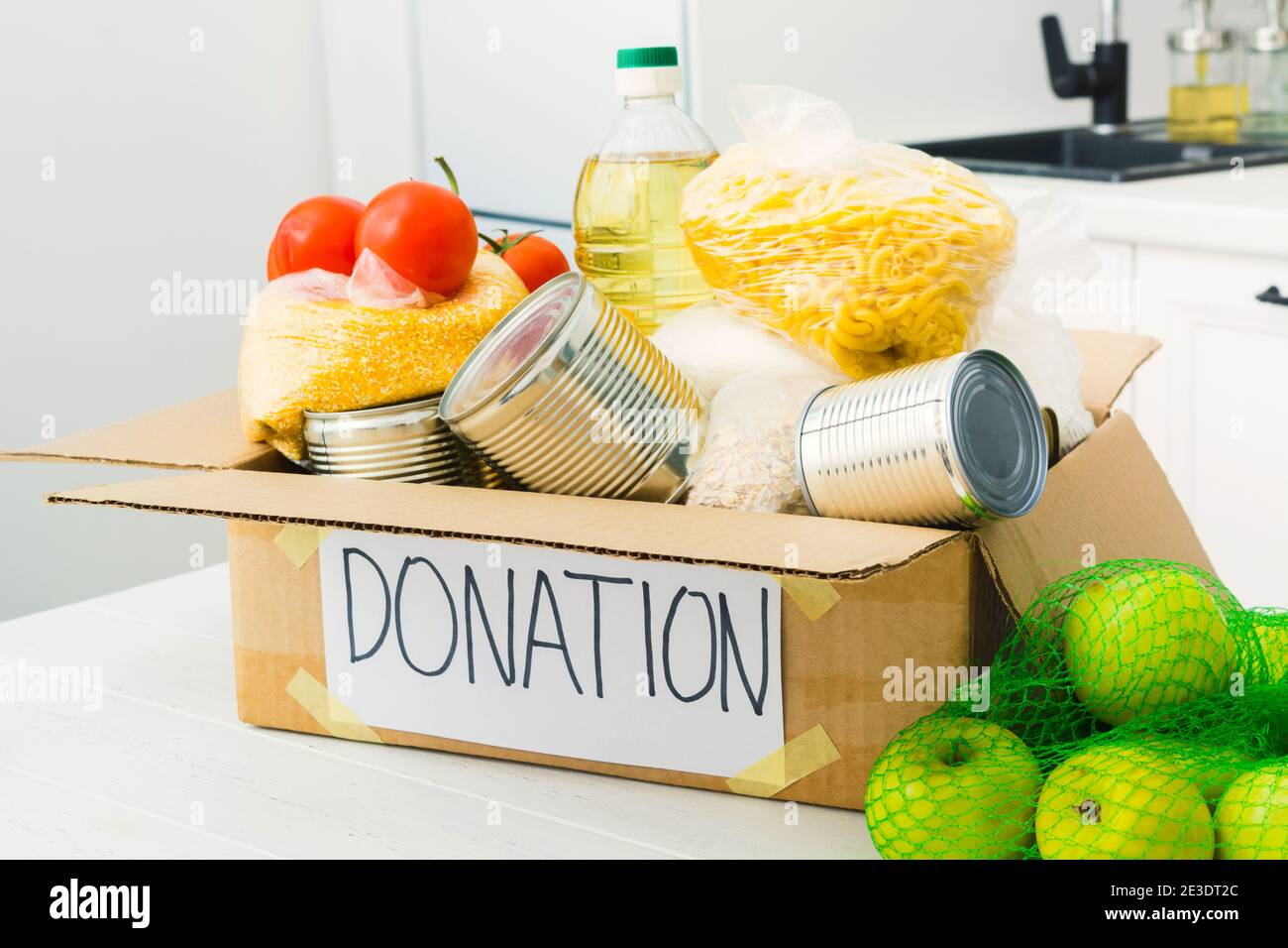 Open donation box with food in kitchen. Help for people. Charity ...