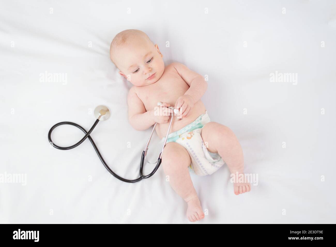 Sweet baby with stethoscope on a white background Stock Photo
