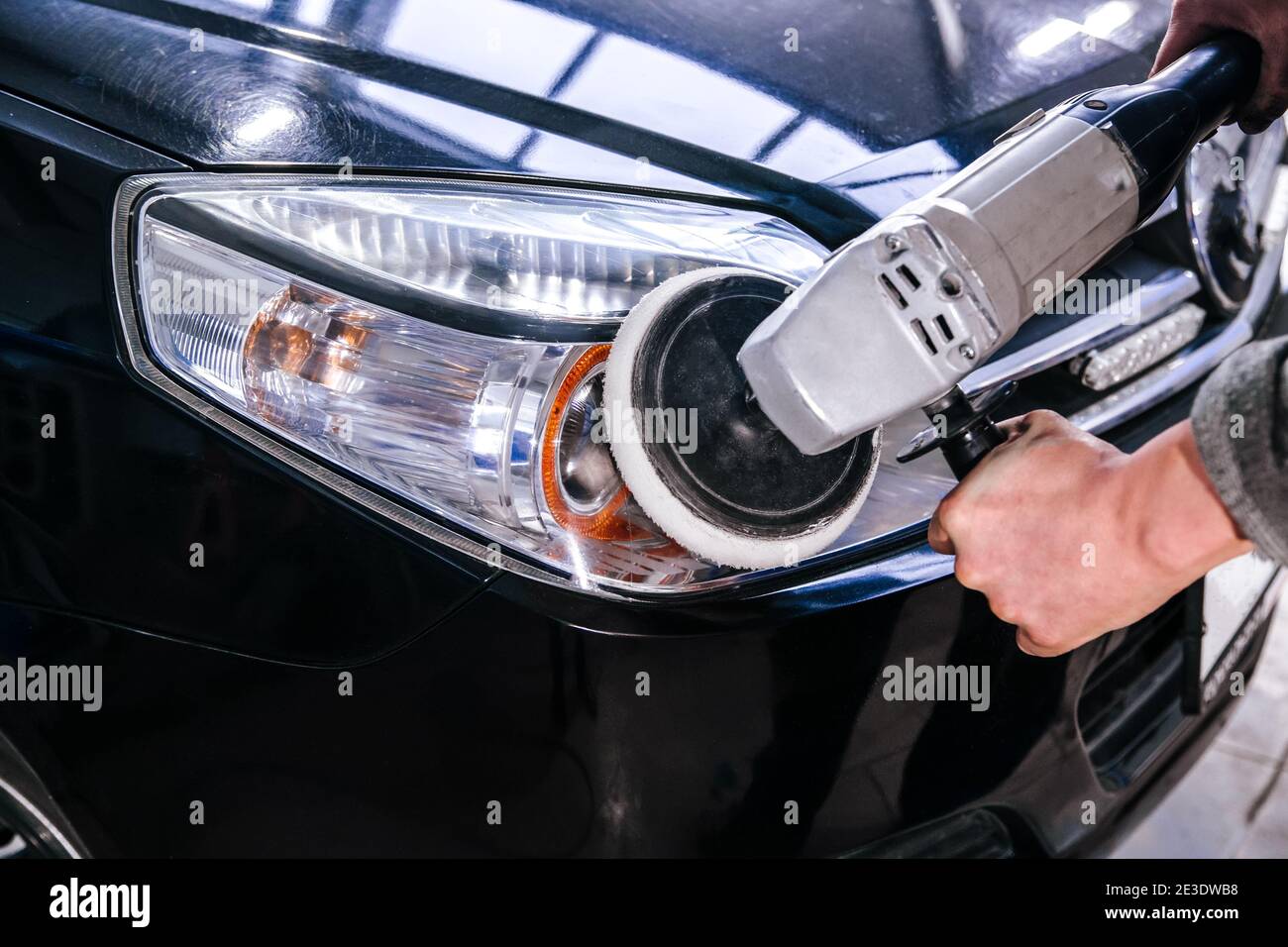 Car headlight cleaning polishing machine at car service at shallow