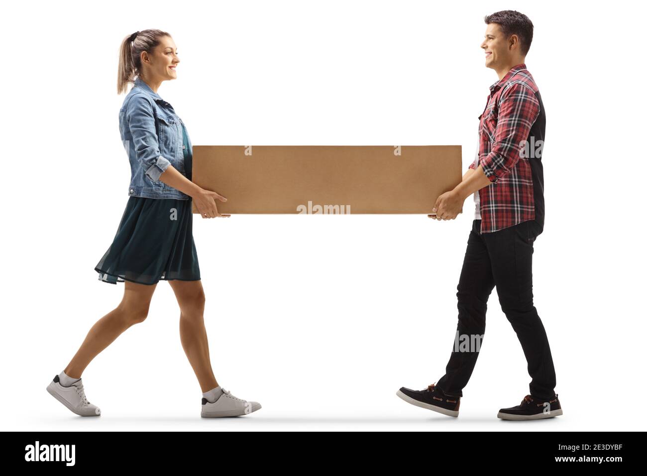 Young man and woman carrying a cardboard box isolated on white background Stock Photo