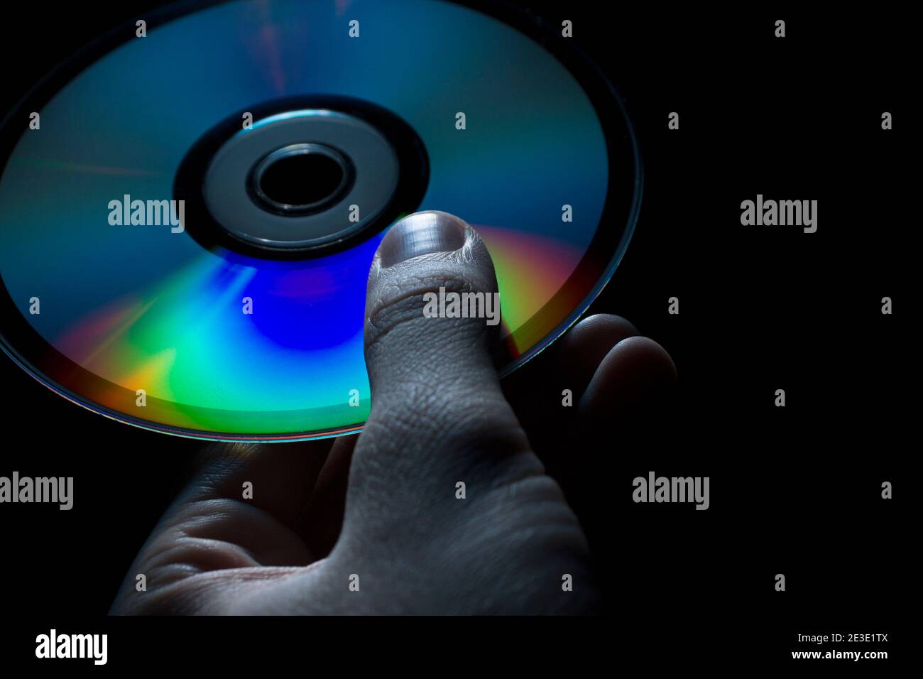 compact-disc in hand on a black background Stock Photo