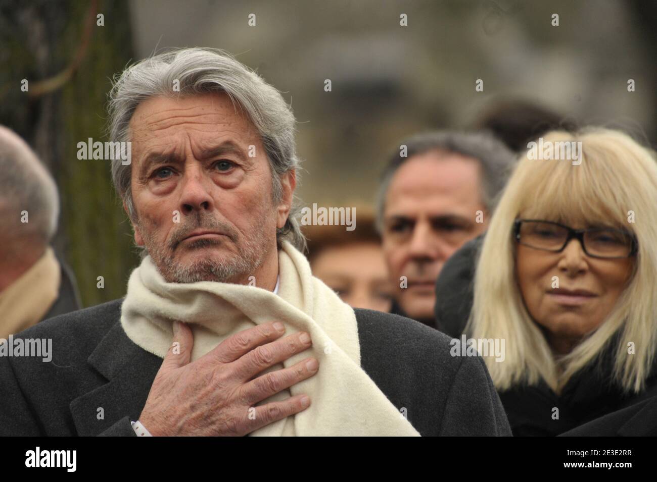 Alain Delon and Mireille Darc attending the funeral of Georges Cravenne who died aged 94, at the Montparnasse cemetery, in Paris, France, on January 14, 2009. Photo by ABACAPRESS.COM Stock Photo