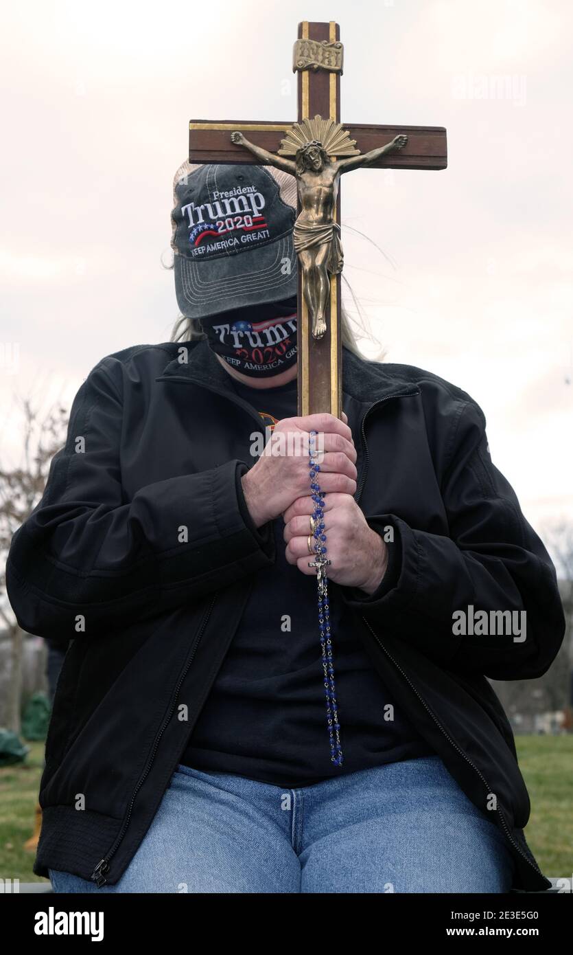 A President Trump supporter prayers for him outside The Capitol Building in Washington, D.C. Stock Photo