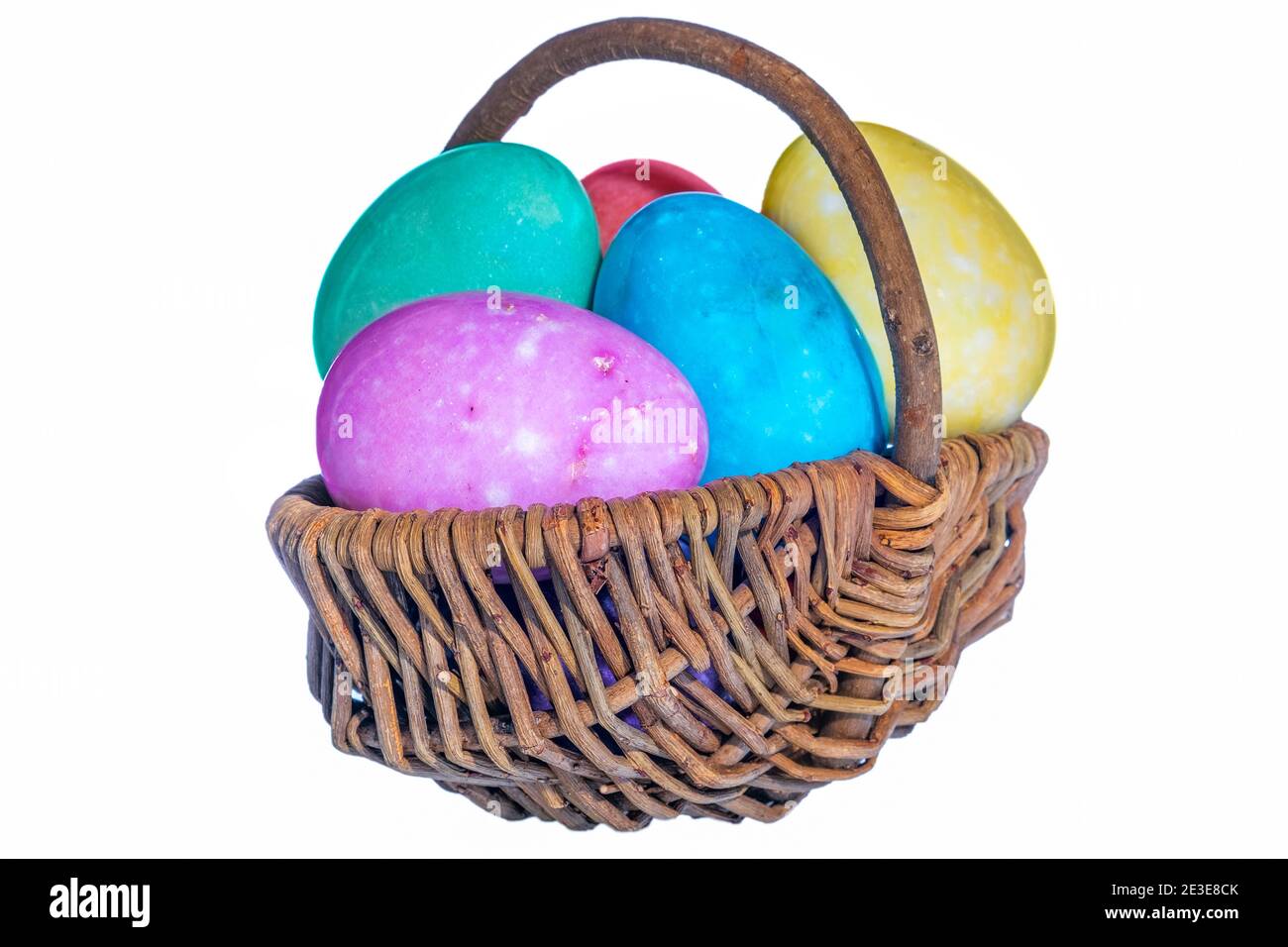 Decorative basket with painted Easter eggs isolated on white background ...