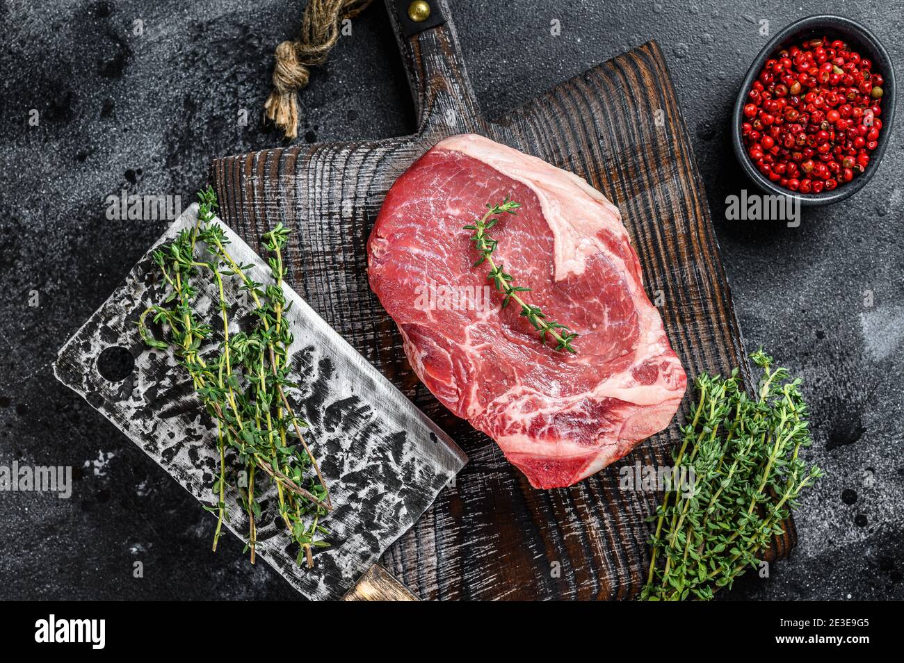 Raw beef club steak. Black ground. Top view Stock Photo Alamy