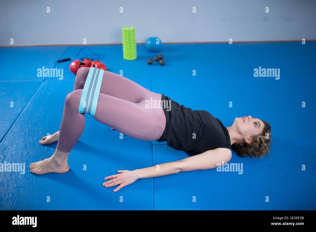 Fitness resistance band loop around thighs, booty band circle hip bands  exercise for glute hip bridge abduction. Yoga fit girl strength training at  gy Stock Photo - Alamy