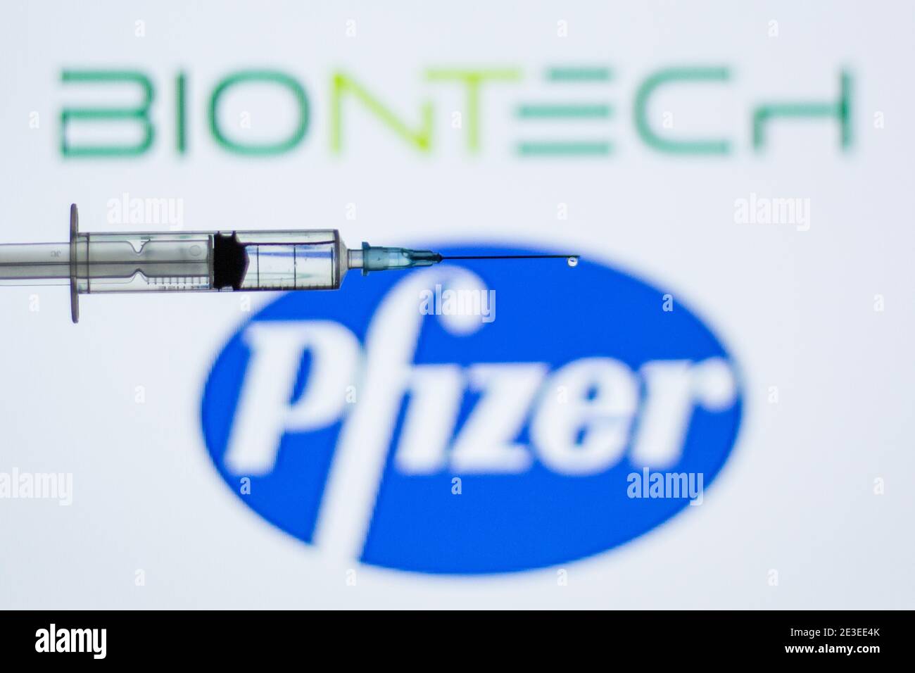 Spain. 18th Jan, 2021. In this illustration, a syringe seen in front of the Pfizer and BioNTech logo.Spain begins to administer the second dose of the Pfizer and BioNTech drug vaccine and the first dose (35,700 doses) of Moderna's drug has been incorporated, which also requires two injections per person. Credit: Thiago Prudencio/SOPA Images/ZUMA Wire/Alamy Live News Stock Photo