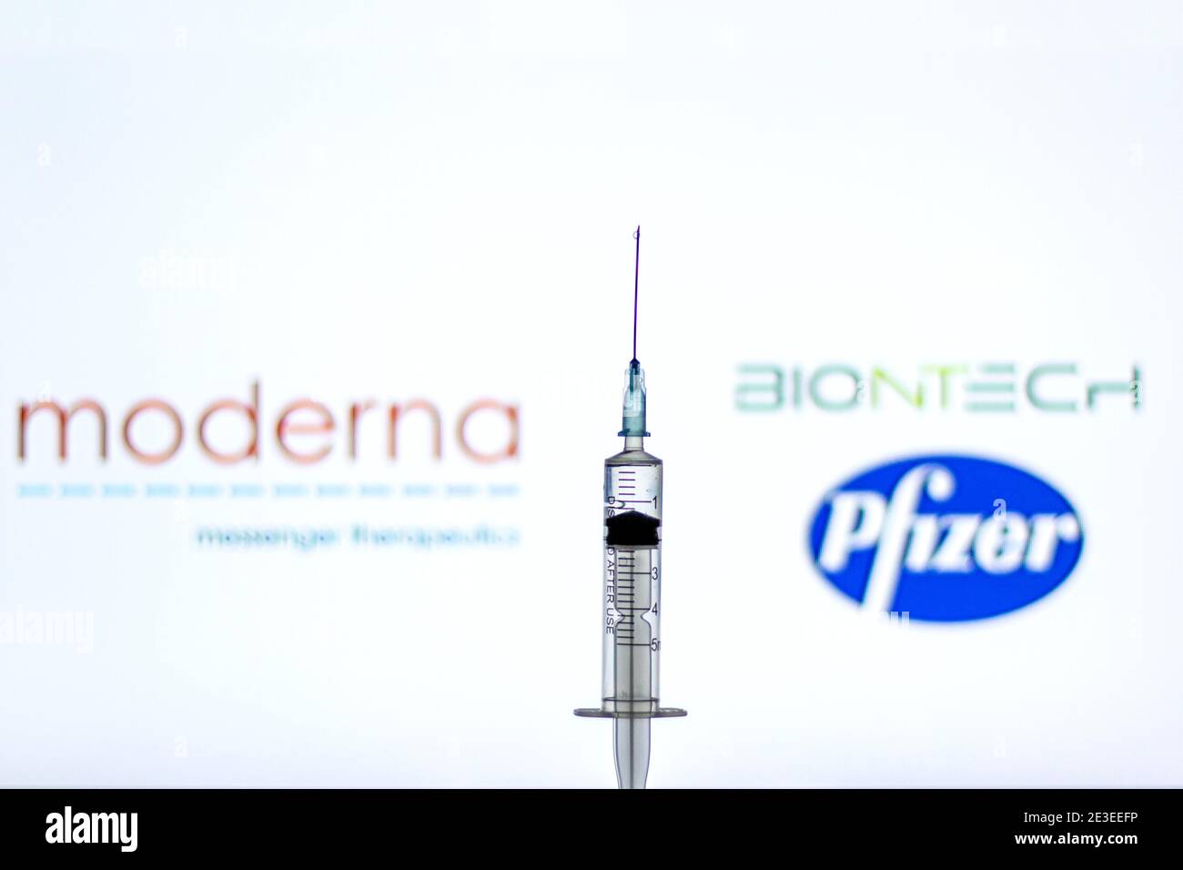 Spain. 18th Jan, 2021. In this illustration, a syringe seen in front of the Moderna, Pfizer and BioNTech logos.Spain begins to administer the second dose of the Pfizer and BioNTech drug vaccine and the first dose (35,700 doses) of Moderna's drug has been incorporated, which also requires two injections per person. Credit: Thiago Prudencio/SOPA Images/ZUMA Wire/Alamy Live News Stock Photo