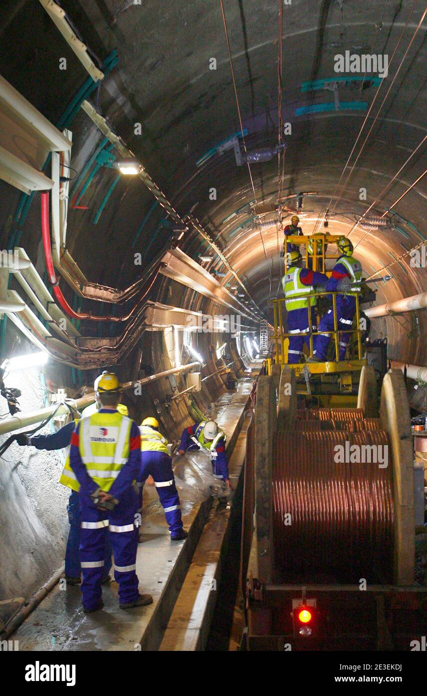 Workers repair damages in the part of the Channel Tunnel known as 'interval six' on January 28, 2009. The 50km-long north tunnel has been closed after a fire broke out on a freight shuttle travelling from Folkestone to Calais. The damaged section will reo Stock Photo