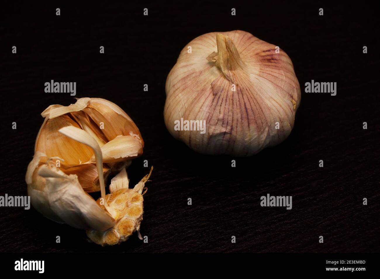Garlic cloves on a black background Stock Photo