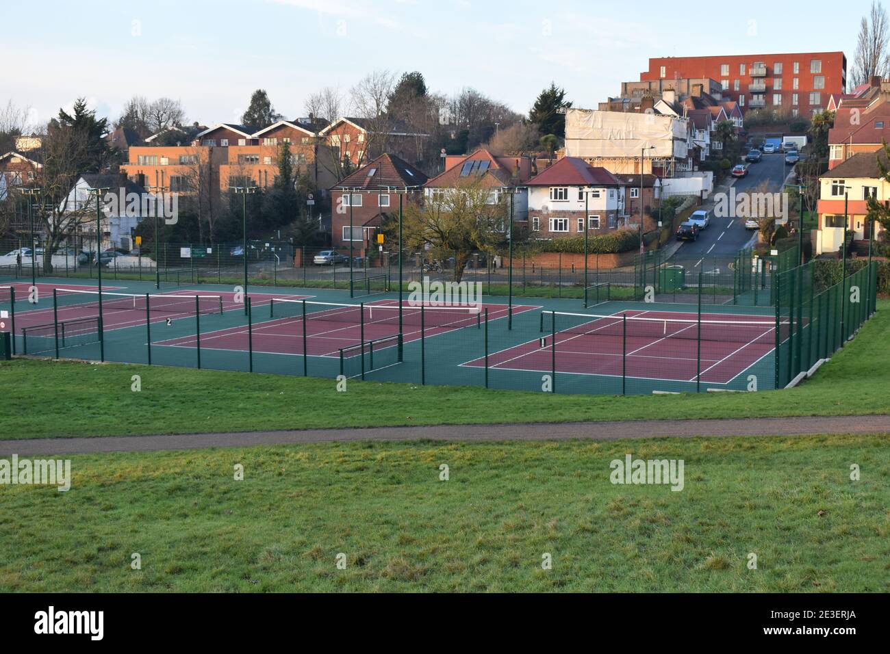 Outdoor macadam pay as you play tennis court. Hard courts are made of uniform rigid material covered with an acrylic surface layer for greater bounce. Stock Photo