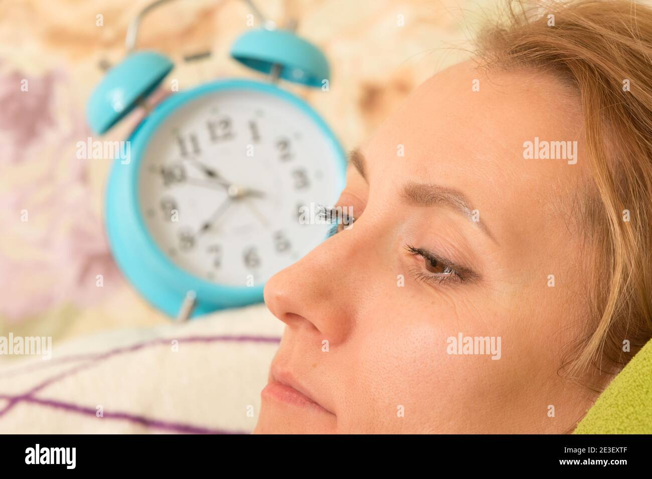 Female portrait with alarm clock. Stock Photo