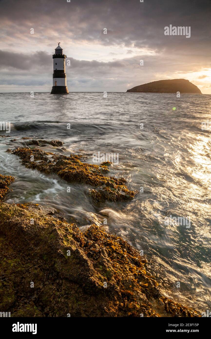 Penmon Point lighthouse and Puffin Island on the coast of Anglesey, North Wales Stock Photo