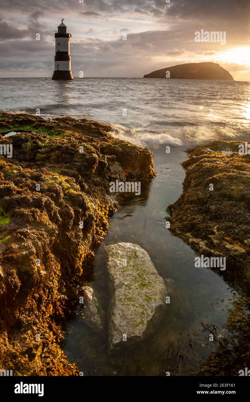 Penmon Point lighthouse and Puffin Island on the coast of Anglesey, North Wales Stock Photo