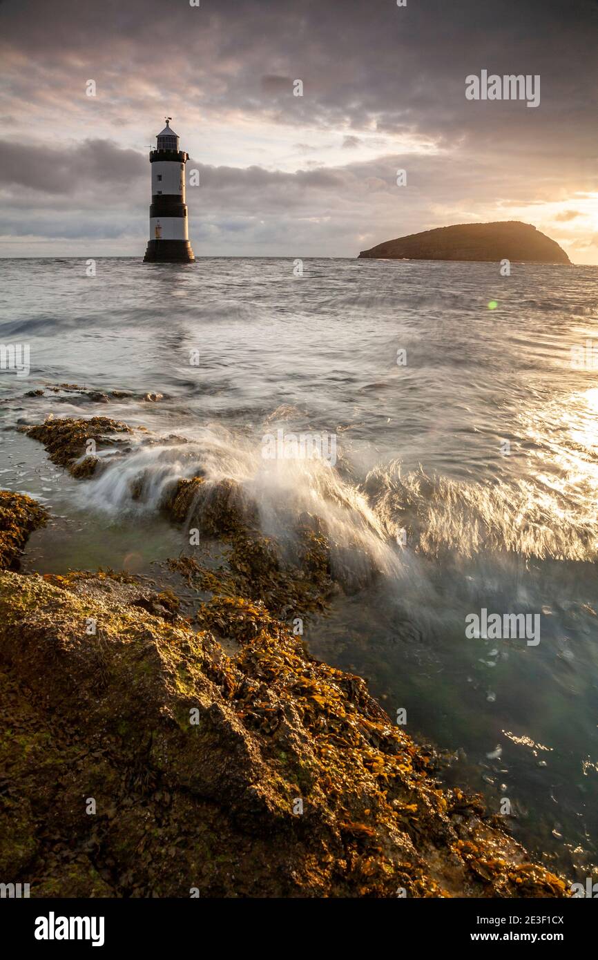 Penmon Point lighthouse and Puffin Island on the coast of Anglesey, North Wales Stock Photo