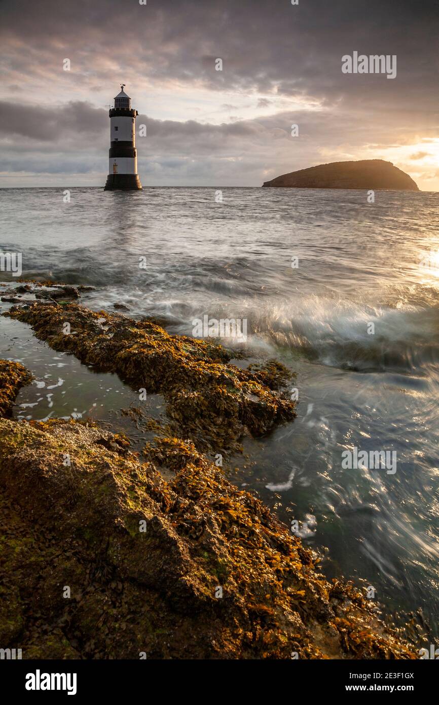 Penmon Point lighthouse and Puffin Island on the coast of Anglesey, North Wales Stock Photo