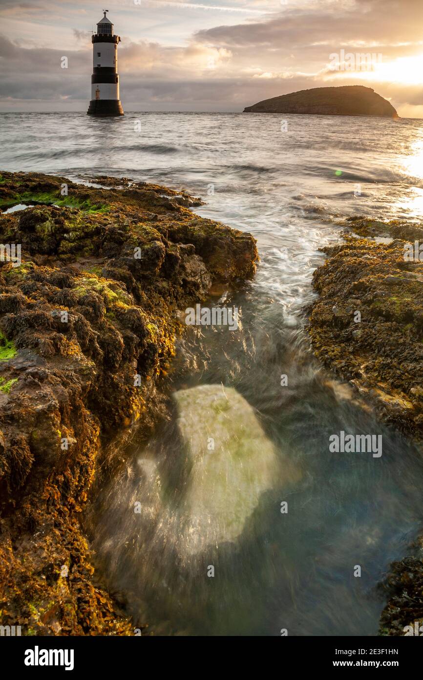 Penmon Point lighthouse and Puffin Island on the coast of Anglesey, North Wales Stock Photo