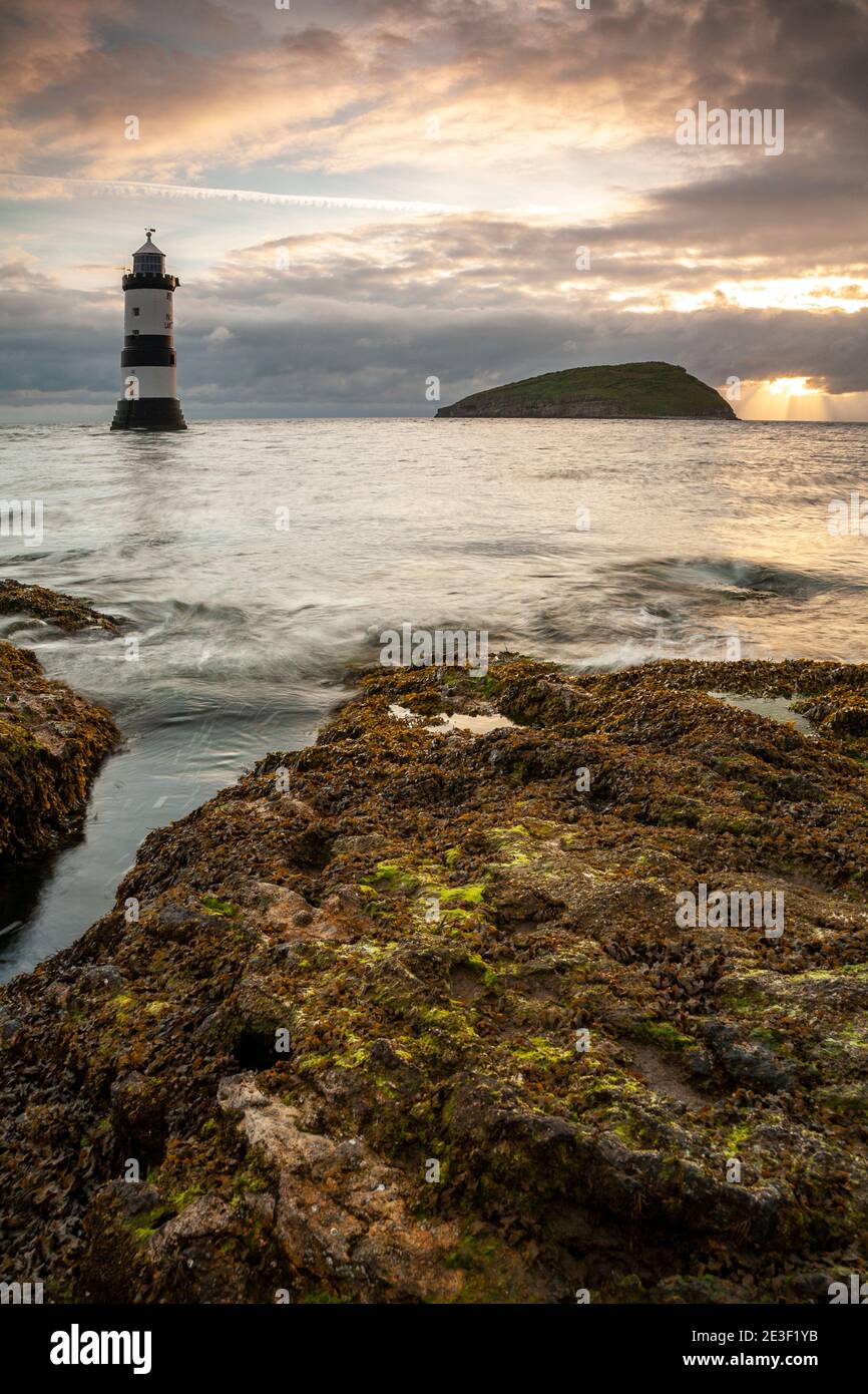 Penmon Point lighthouse and Puffin Island on the coast of Anglesey, North Wales Stock Photo