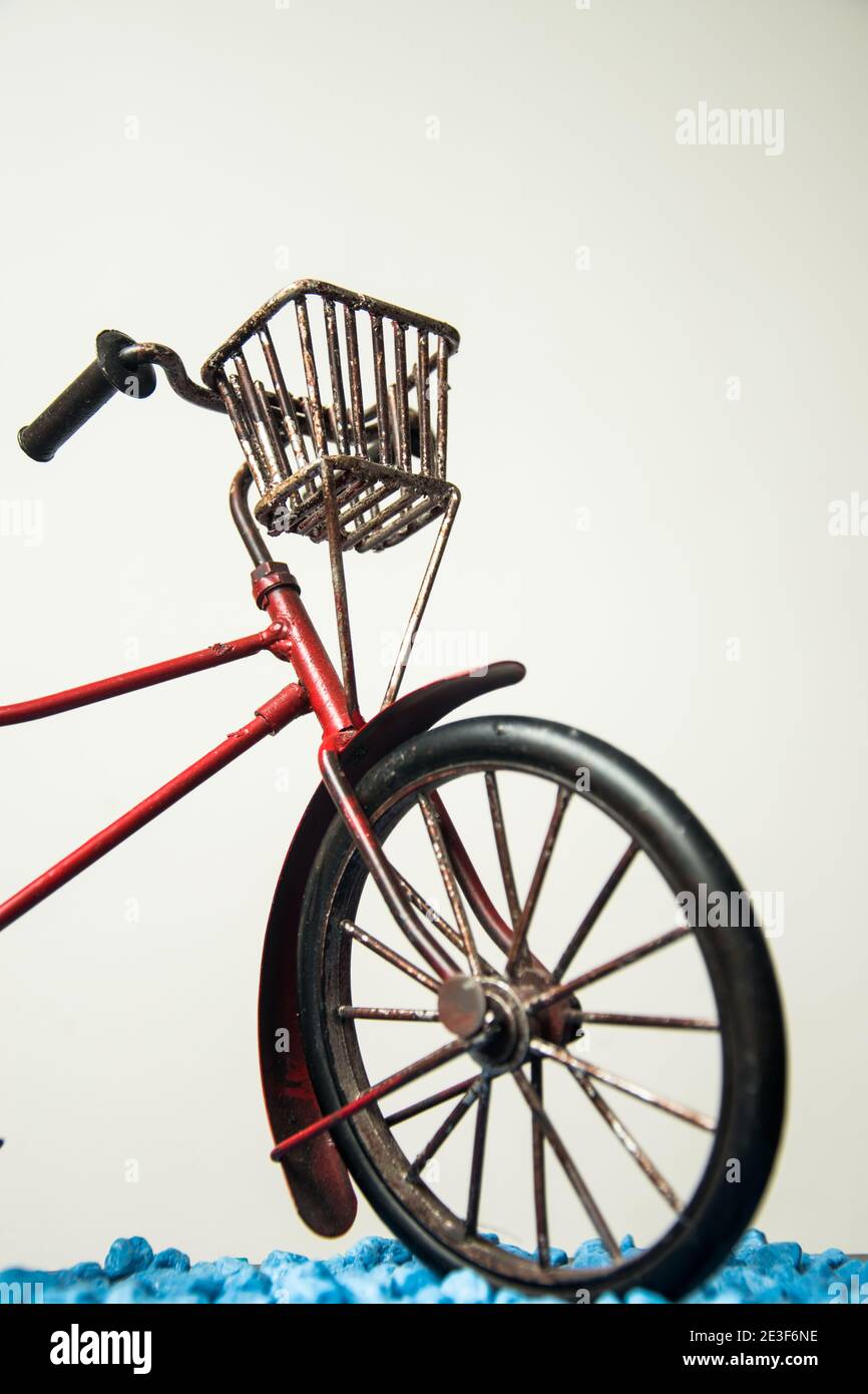Vintage red bicycle with a metal basket with a white background Stock