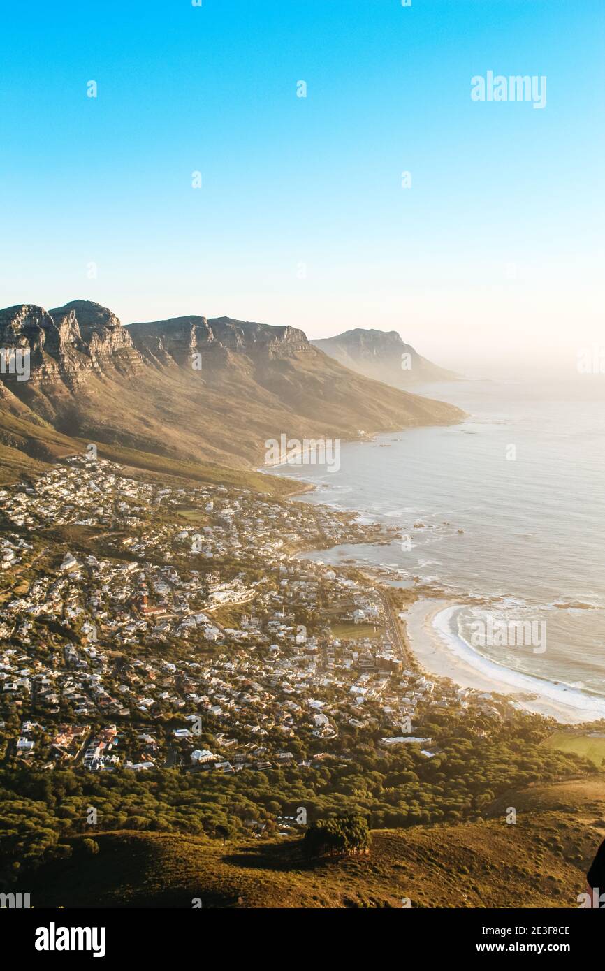 View of the 12 apostles and Camps Bay seen from the peak of Lions Head lookout point at sunset. Stock Photo