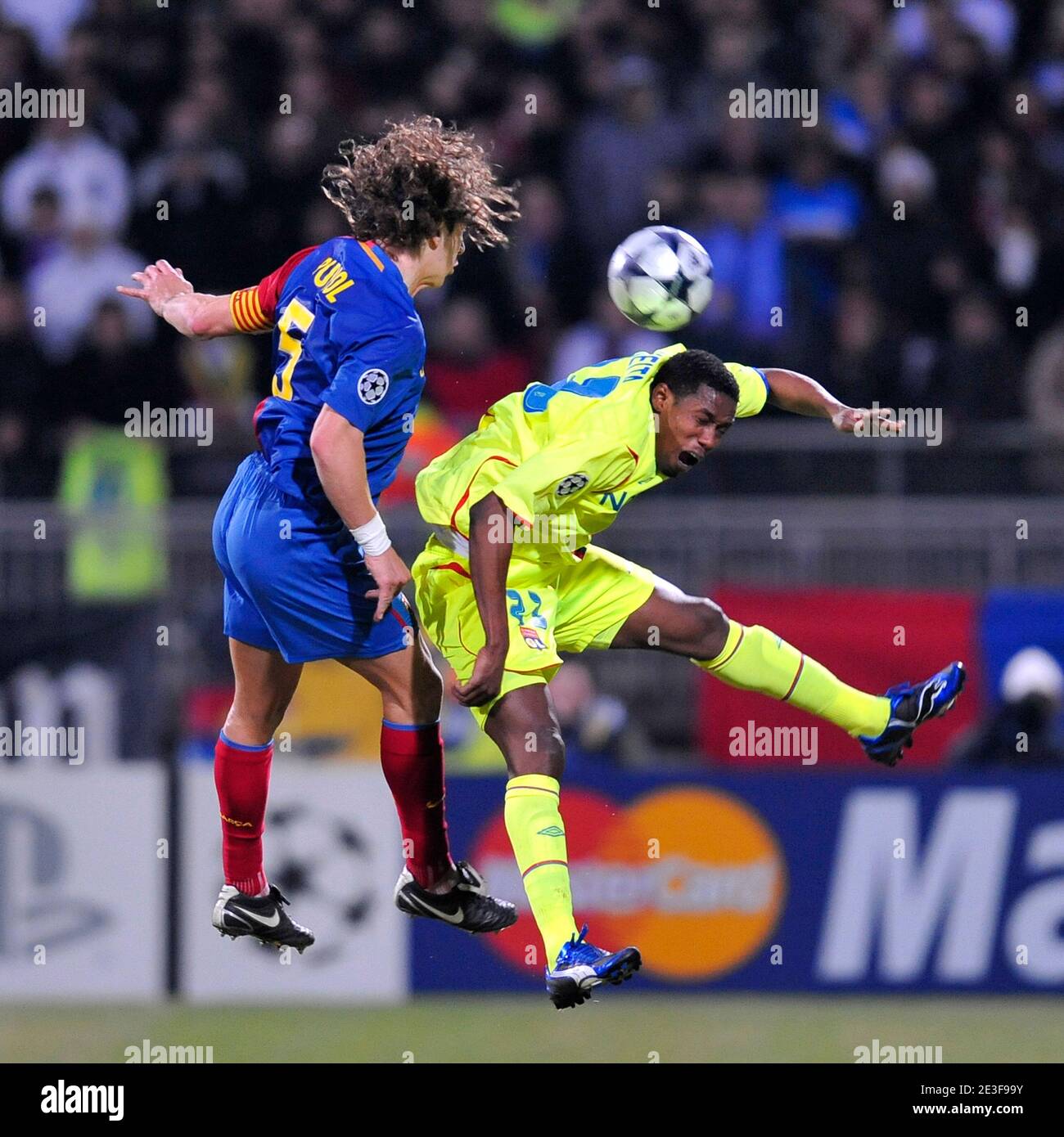 Barcelona's Carles Puyol and Lyon's Kader Keita battle for the ball in air  during the UEFA Champions League - First Knockout Round - First Leg - Lyon  vs Barcelona in Lyon, France