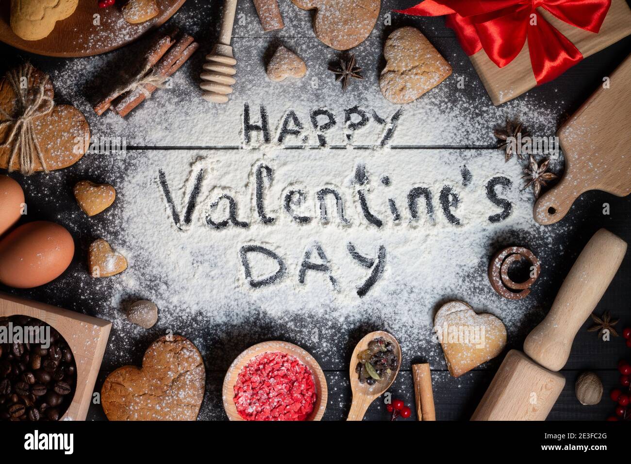 Happy Valentines Day written on flour. Gingerbread heart shaped ...