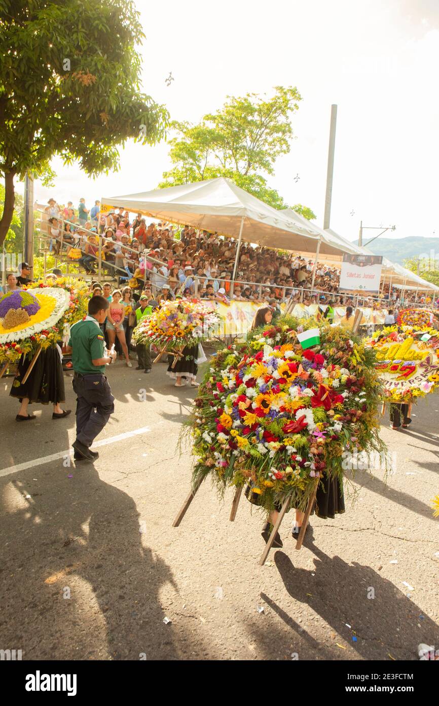 Girl carrying large floral arrangement in the Desfile de Silleteros