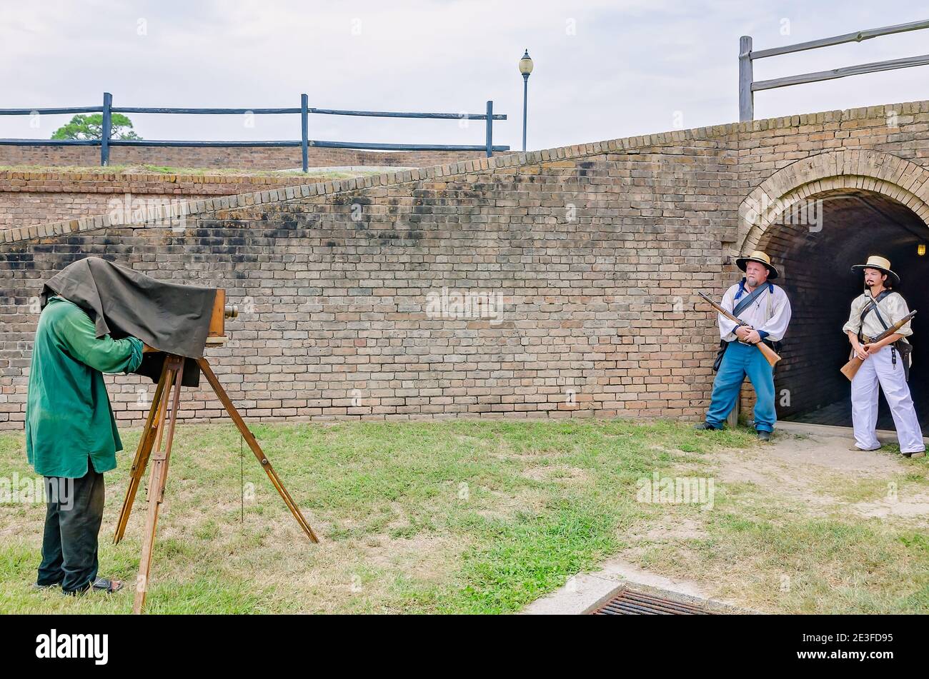 A photographer uses an antique view camera to photograph Civil War reenactors at Fort Gaines during a reenactment of the 150th Battle of Mobile Bay. Stock Photo