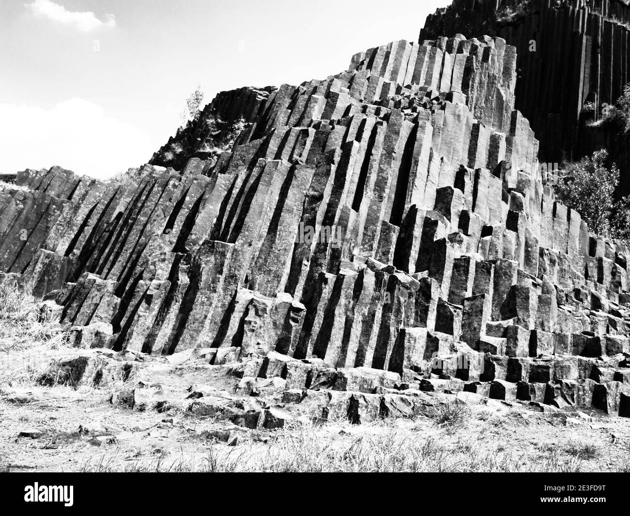 Unique basalt organ pipes rock formation of Panska skala near Kamenicky Senov in Northern Bohemia, Czech Republic, Europe. Black and white image. Stock Photo