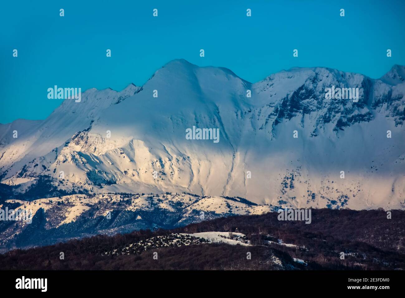 Hunting Yarn on Lig Taken From Sveta Gora. Sun on Krn Mountain as Background. Half Mountain in Shadow. Stock Photo