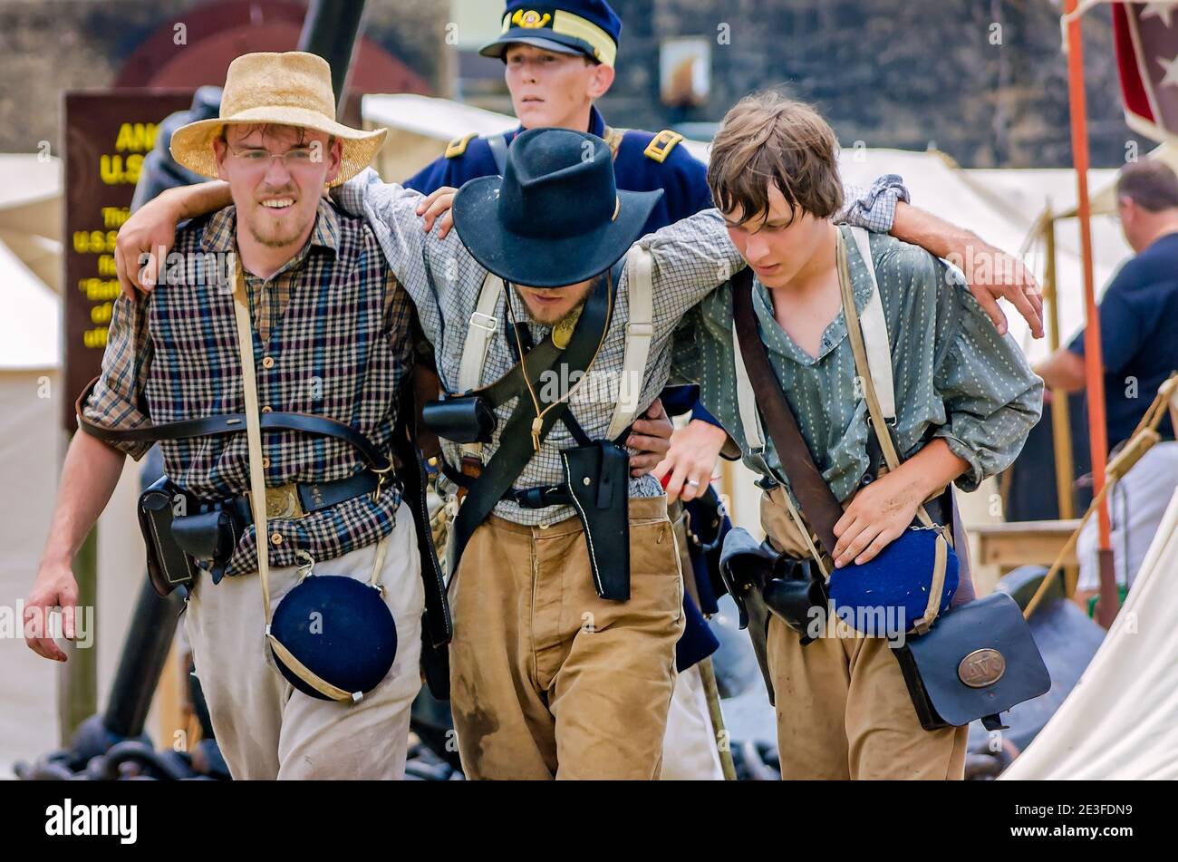 Civil War reenactors representing the Confederate Army help a wounded soldier at Fort Gaines