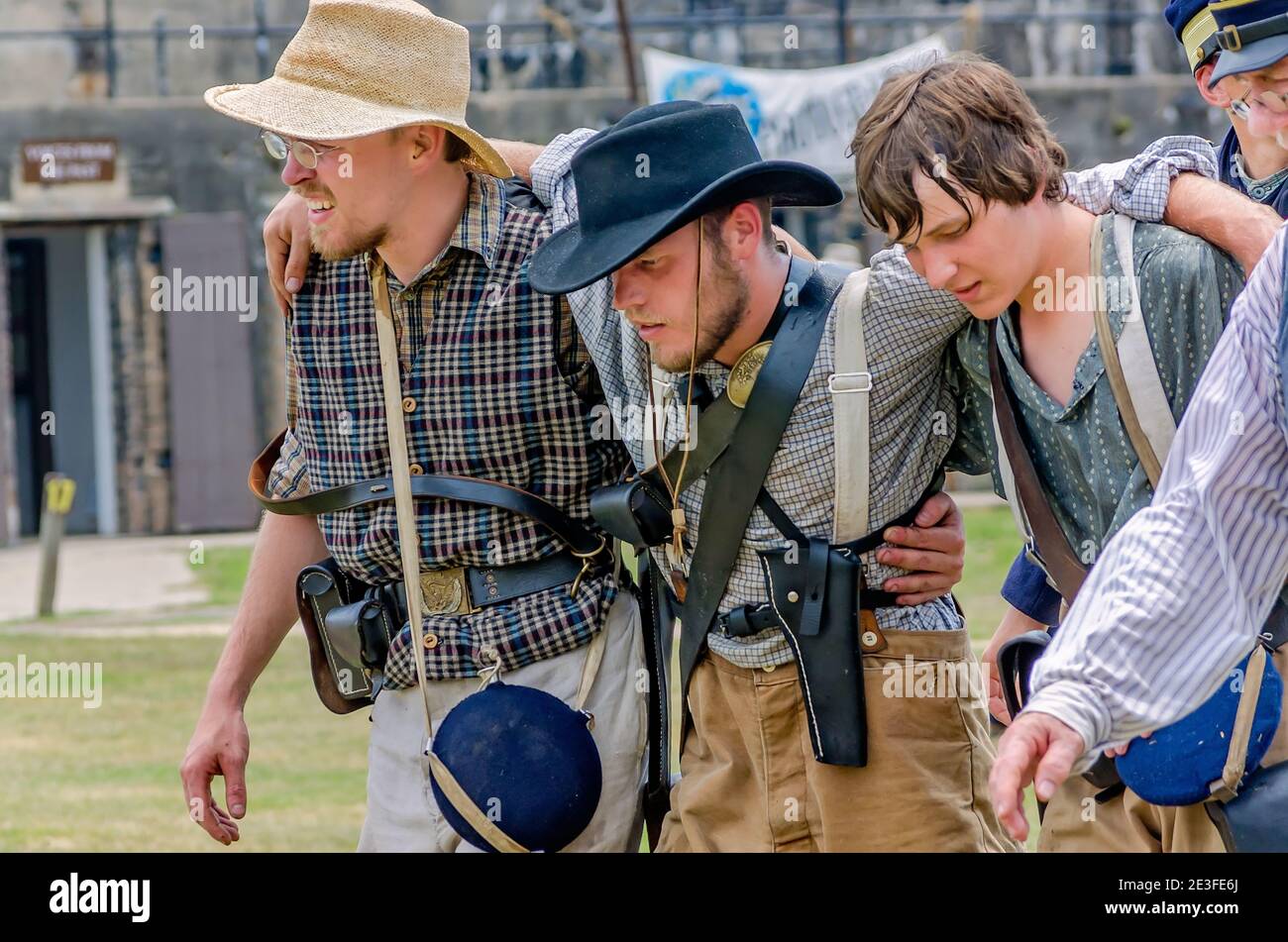 Civil War reenactors representing the Confederate Army help a wounded soldier at Fort Gaines during a reenactment of the 150th Battle of Mobile Bay. Stock Photo