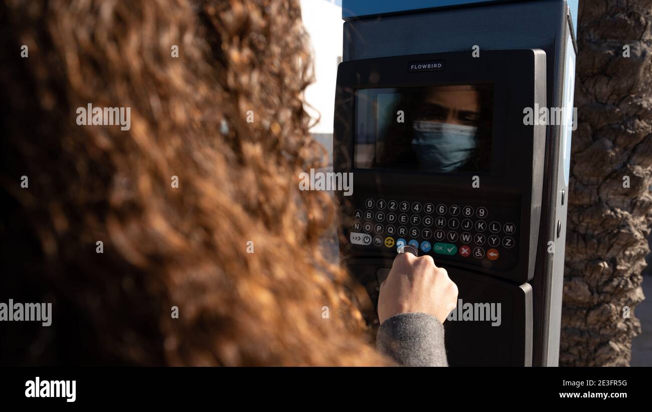 woman using parking meter Stock Photo Alamy