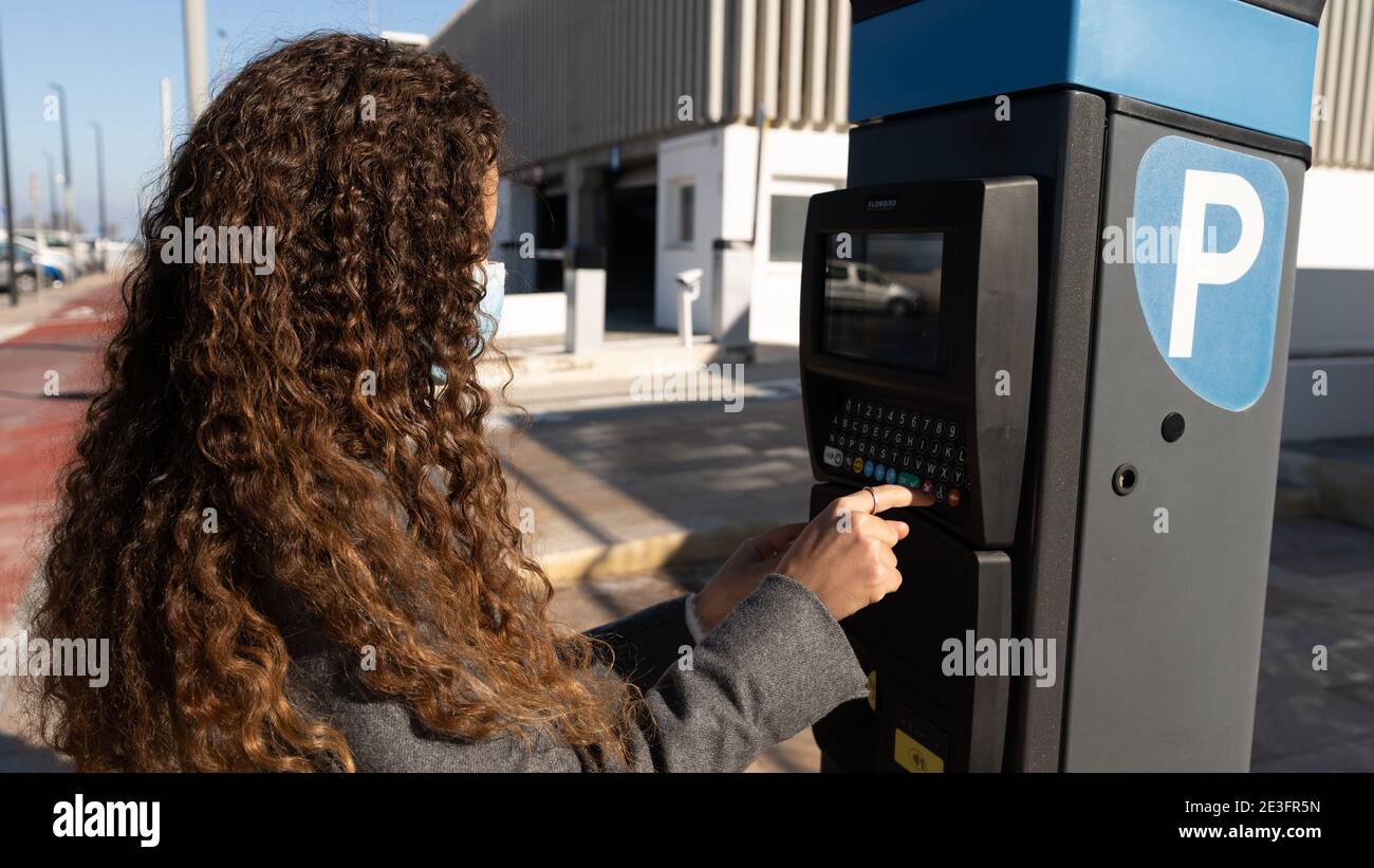 woman using parking meter Stock Photo Alamy