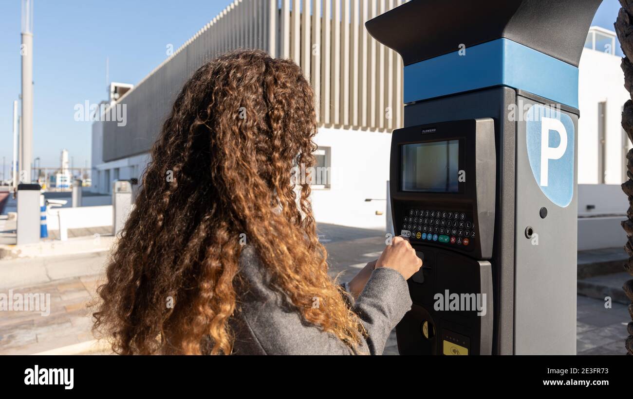 woman using parking meter Stock Photo Alamy