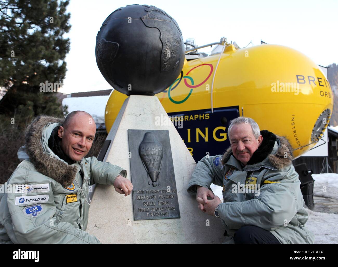 Brian Jones and Bertrand Piccard pose in Chateau-d'Oex, Switzerland on March 21, 2009. Bertrand Piccard (CH) and Brian Jones (GB) landed in the Egyptian desert on board the Breitling Orbiter 3. They had just completed the first non-stop round-the-world balloon flight, taking them 45,633 km from the Swiss village of Chateau-d'Oex in 19 days, 21 hours and 47 minutes. This flight, which broke 7 world records, remains the longest in effective distance and duration in the history of aviation. This 'Jules Verne dream', considered as the last great adventure of the 20th century, was initiated in the Stock Photo