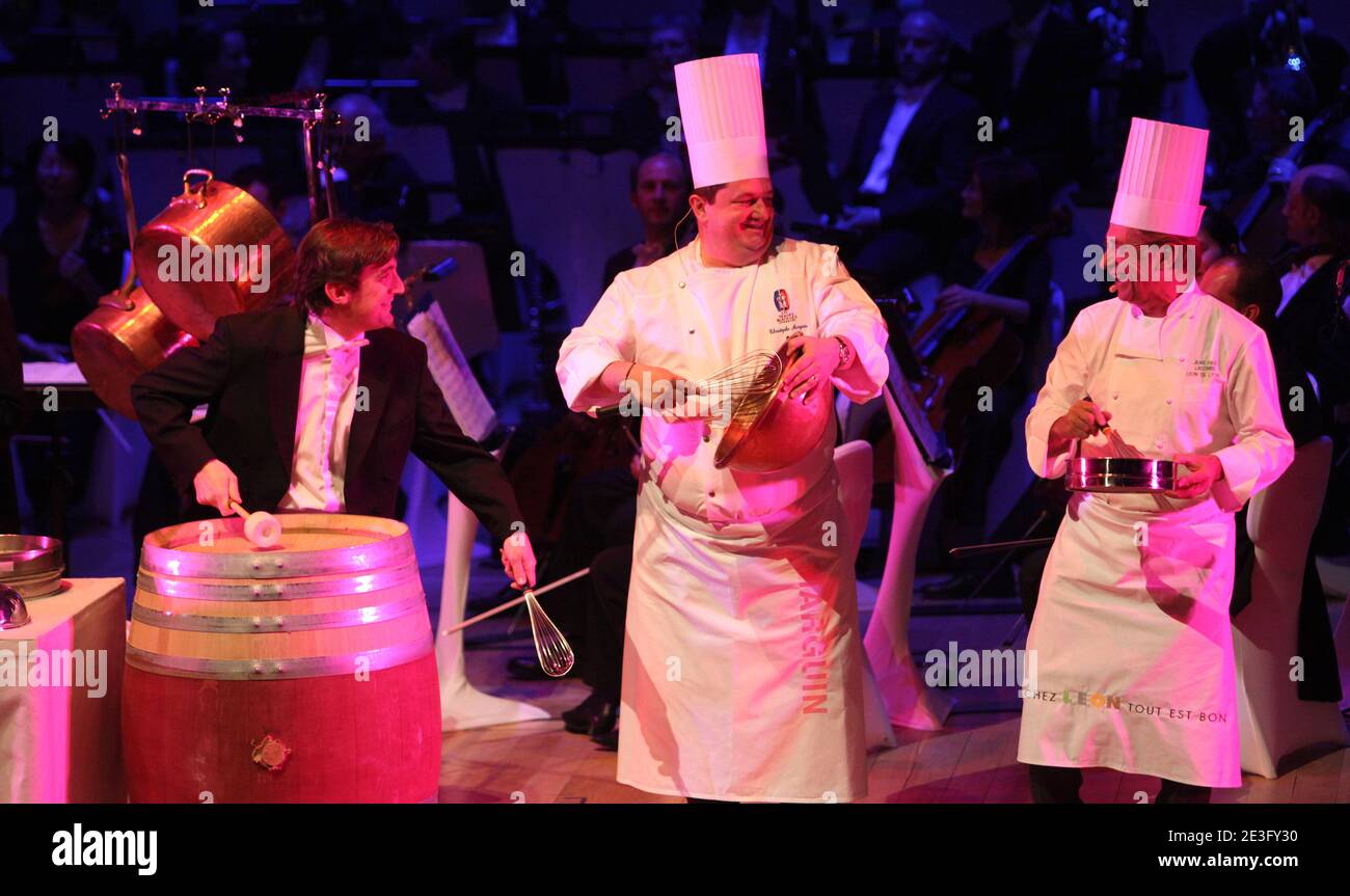 Chefs perform live during the 'concert delice' in Lyon, France on March 26, 2009. The chefs play different rhythm of music (Strauss, Tchaikovsky, Puccini) and play with the Orchestra on a musical partition which mixes instruments and tools of the head-cooks, the National Orchestra of Lyons and chef from 'toques blanches lyonnaises': Jean-Paul Lacombe, Guy Lassausaie, Christophe Marguin et Mathieu Viannay and a chinese chef from Canton Pinghui Chen. Photo by Vincent Dargent/ABACAPRESS.COM Stock Photo
