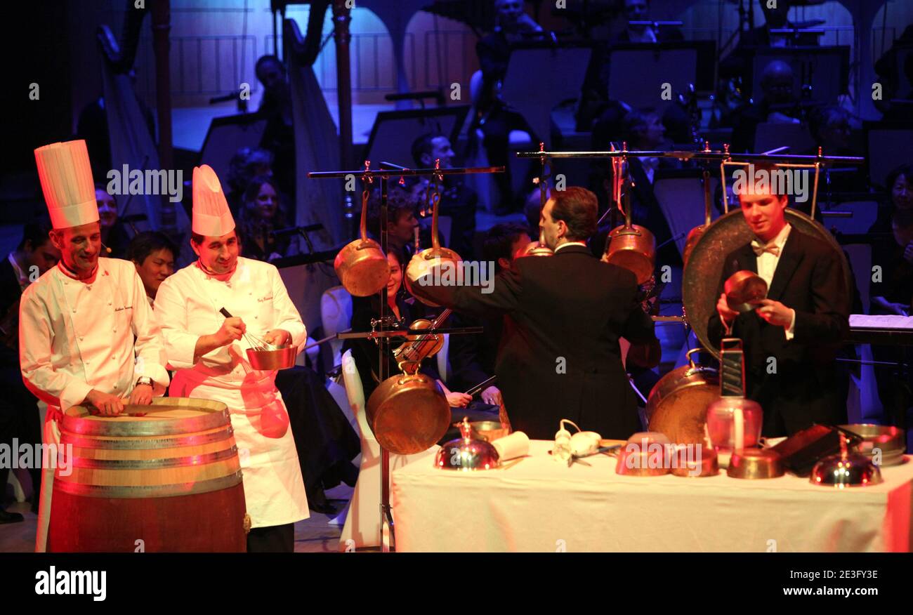 Chefs perform live during the 'concert delice' in Lyon, France on March 26, 2009. The chefs play different rhythm of music (Strauss, Tchaikovsky, Puccini) and play with the Orchestra on a musical partition which mixes instruments and tools of the head-cooks, the National Orchestra of Lyons and chef from 'toques blanches lyonnaises': Jean-Paul Lacombe, Guy Lassausaie, Christophe Marguin et Mathieu Viannay and a chinese chef from Canton Pinghui Chen. Photo by Vincent Dargent/ABACAPRESS.COM Stock Photo
