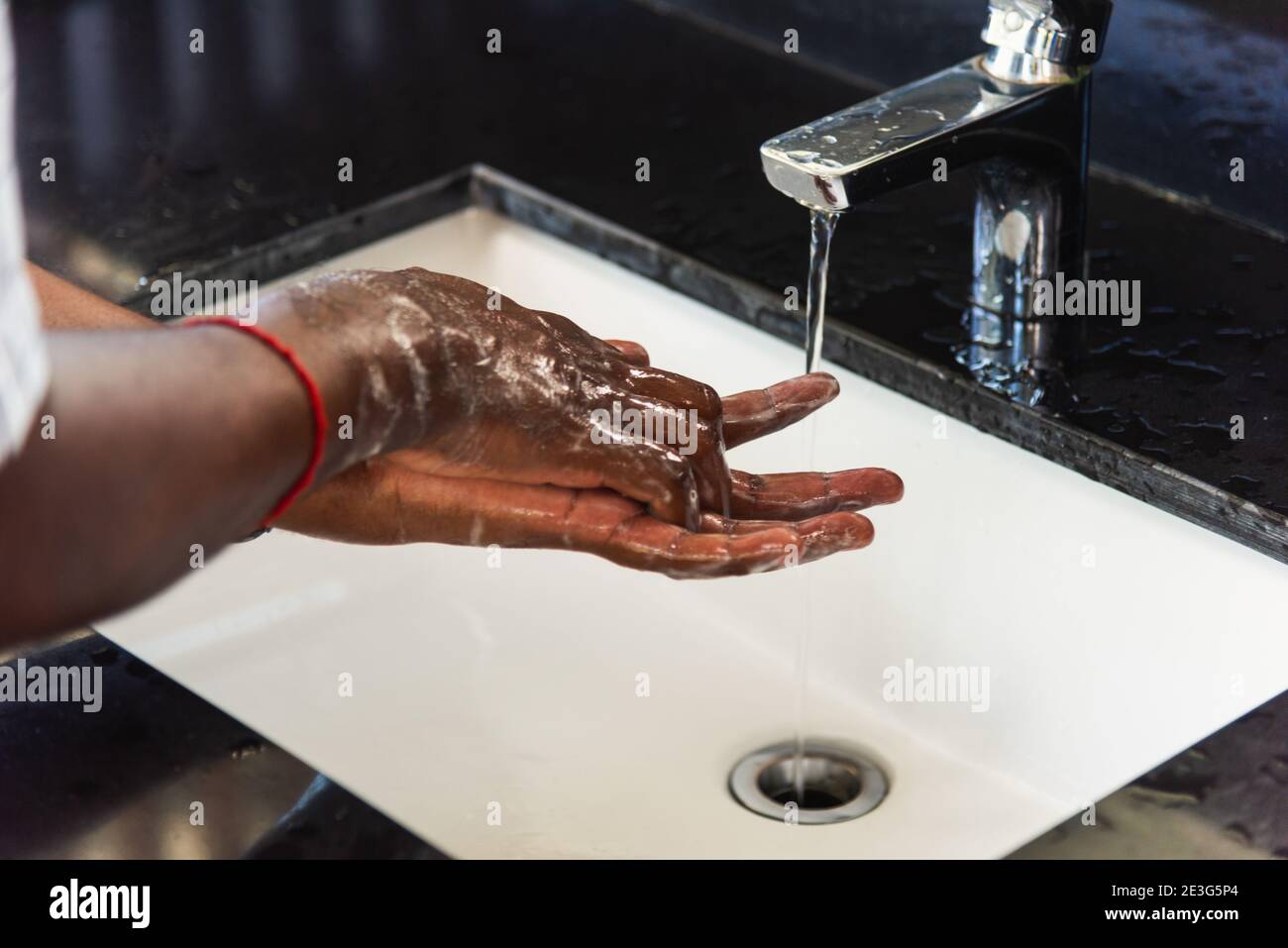 Closeup washing black man hands rubbing with soap and water in sinks to ...
