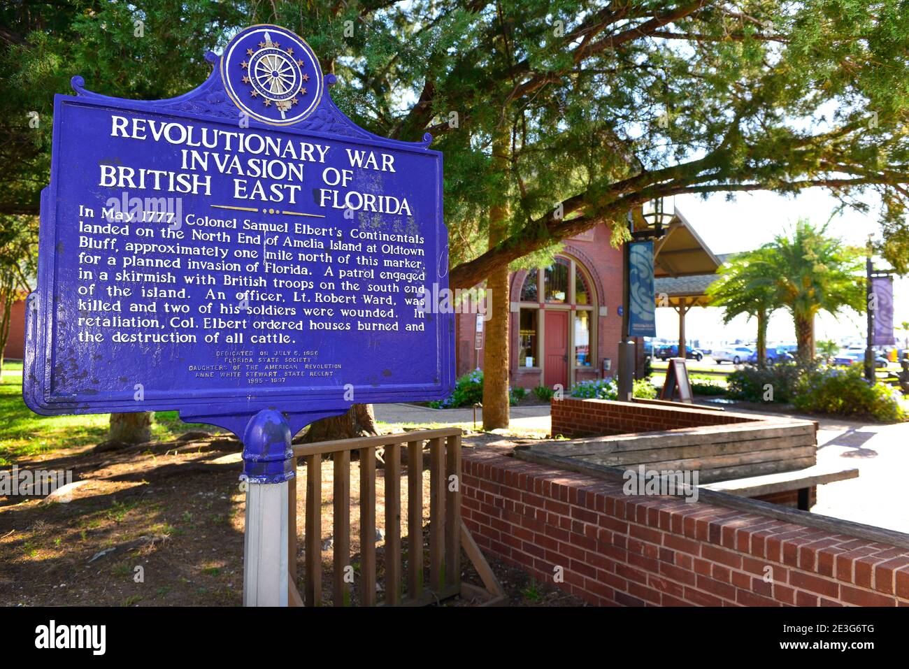 Aged, cobalt blue historical metal sign tells of the Revolutionary War Invasion of British East Florida, in Fernandina, FL on Amelia Island Stock Photo