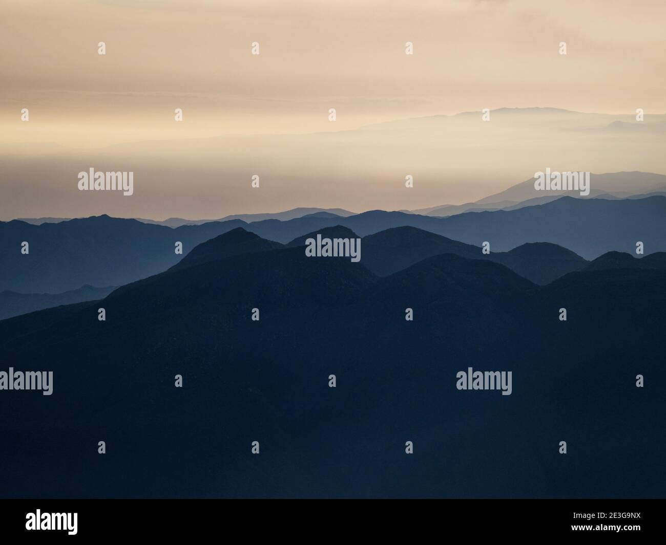 Panorama view of mountain range silhouette layers haze dust fog clouds ...
