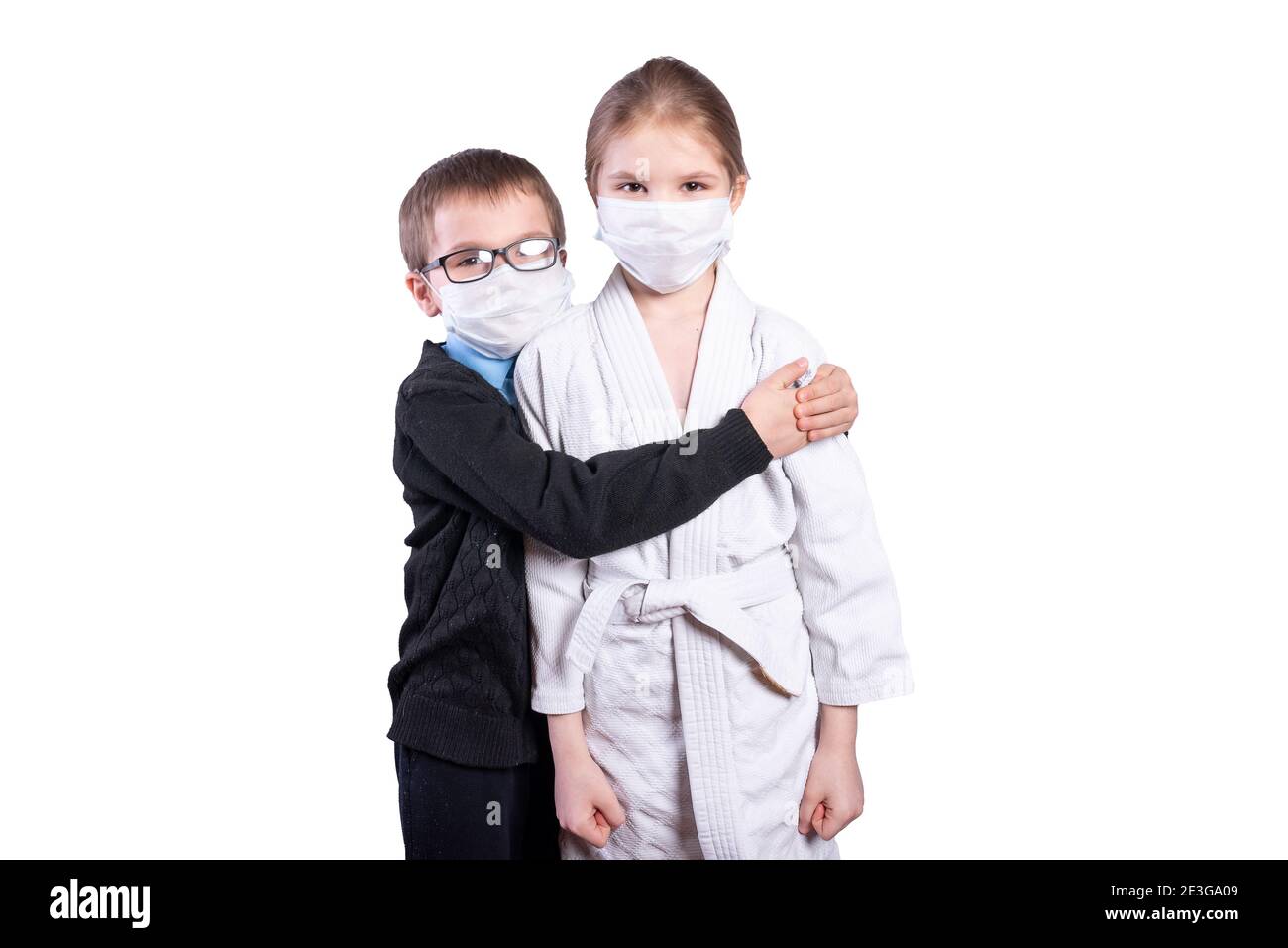 Boy schoolboy hugs a girl athlete. Masked. Isolated on white background. High quality photo Stock Photo