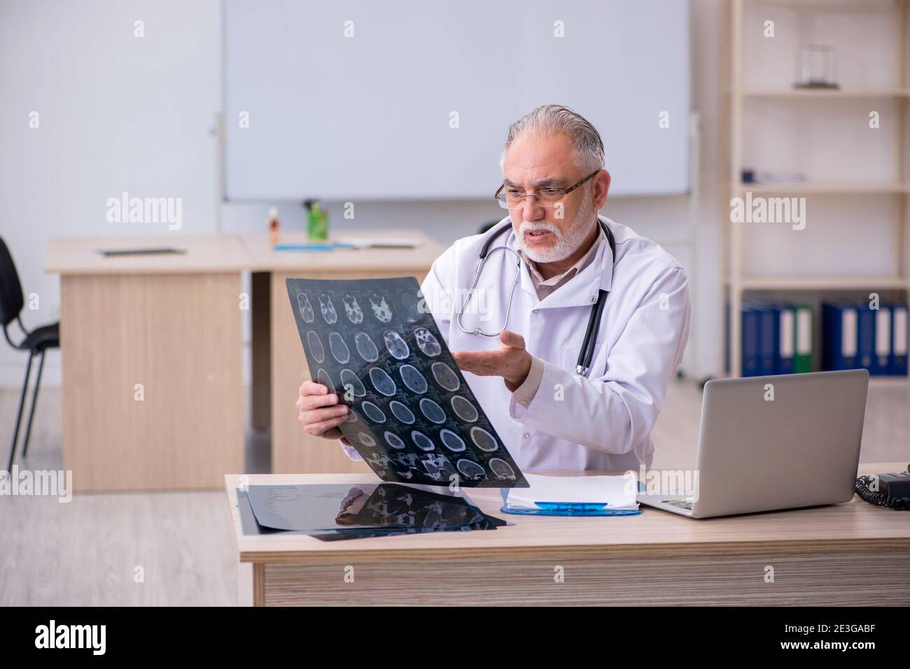 Old doctor radiologist working in the clinic Stock Photo - Alamy