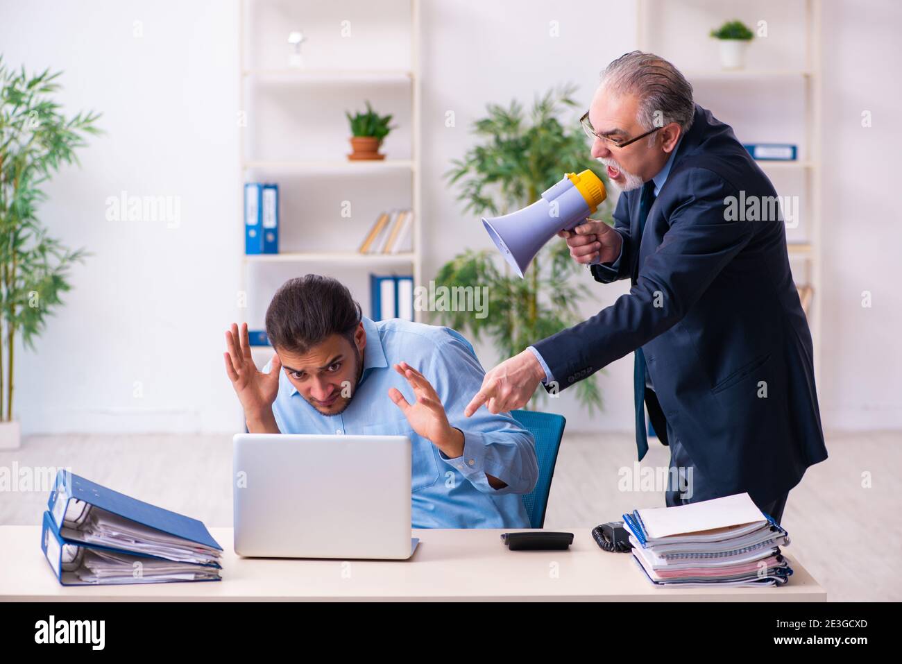 Old boss and young assistant in the office Stock Photo - Alamy