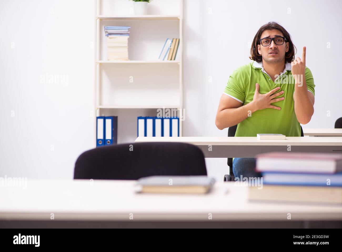 Young male student in the classroom studying Stock Photo - Alamy