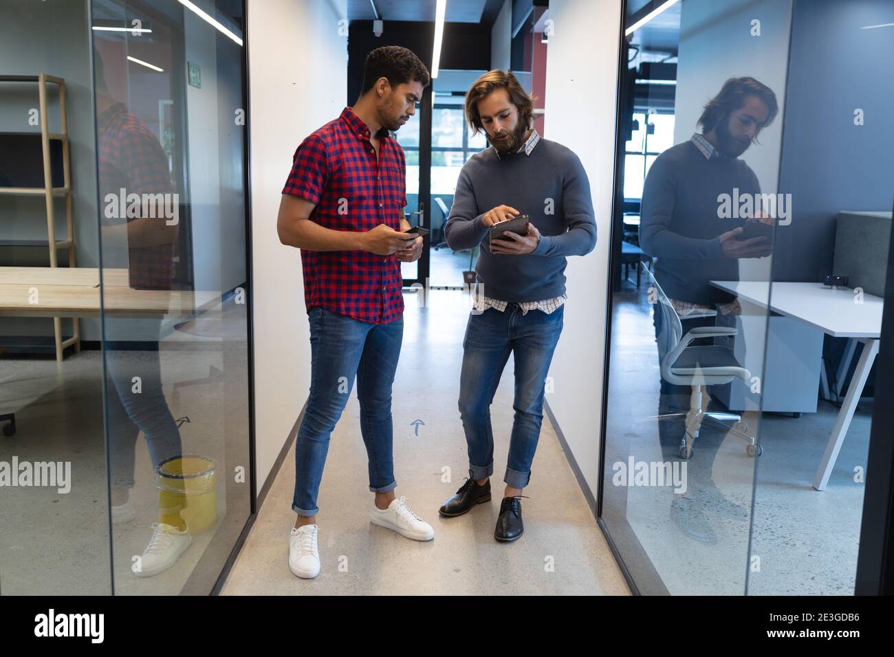 Two diverse businessmen working in creative office Stock Photo