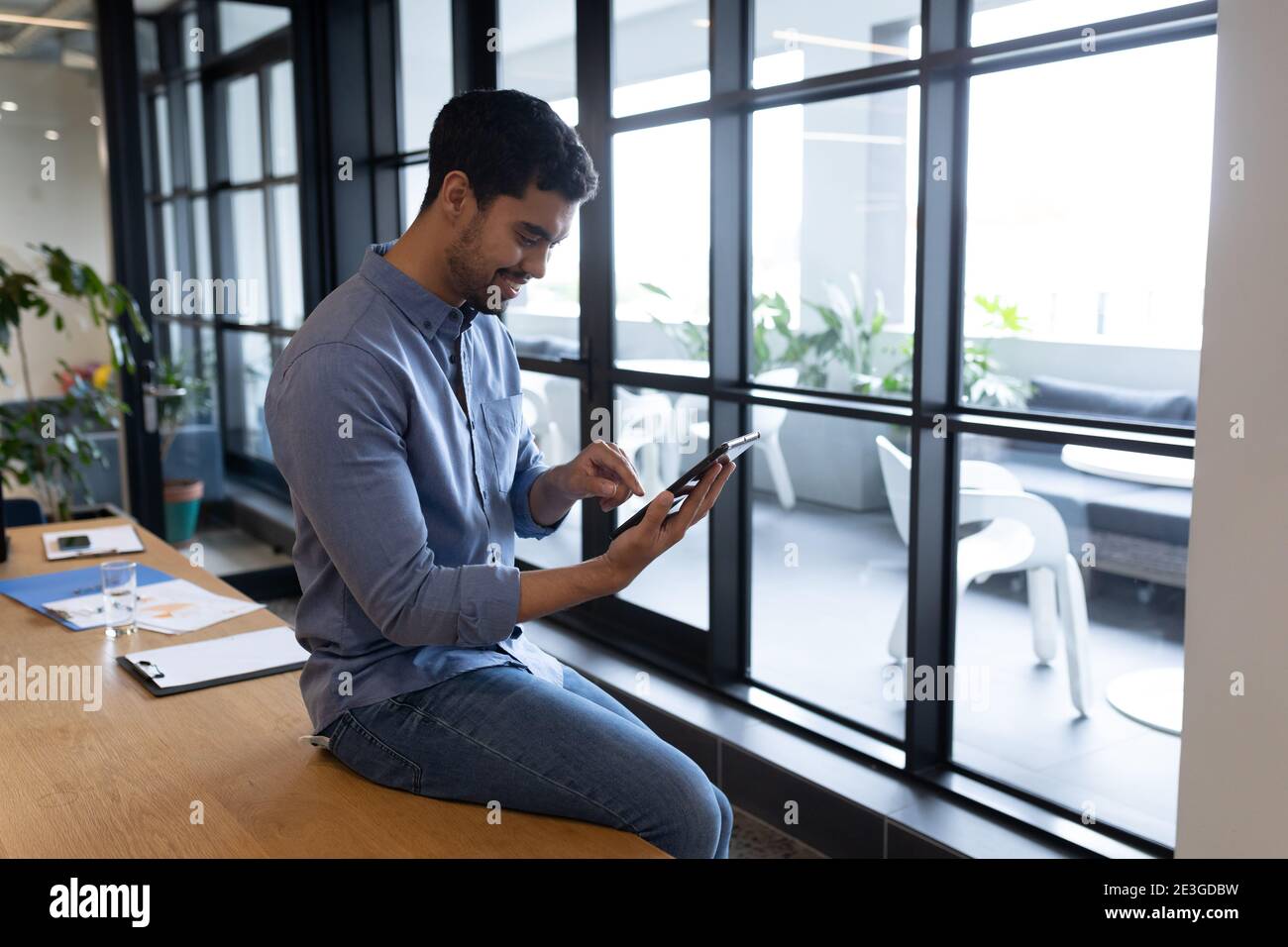 Mixed race businessman working in creative office Stock Photo